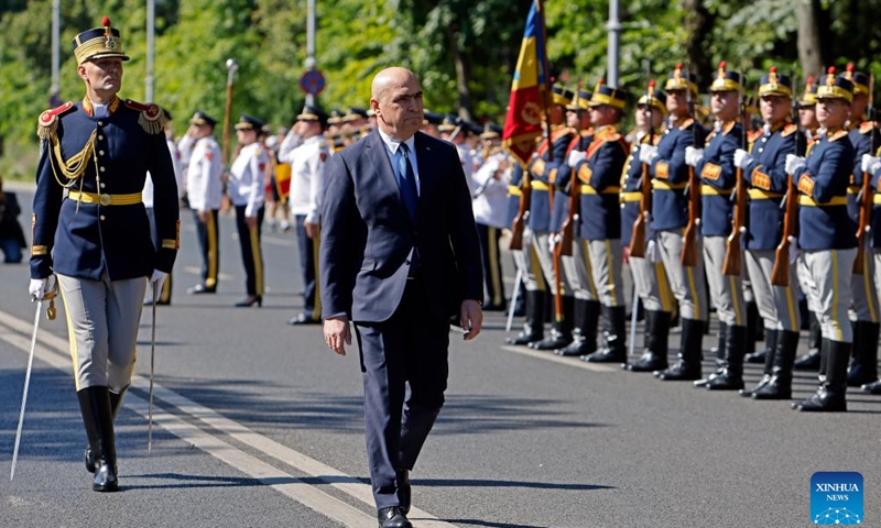 Romanian Prime Minister Ilie Bolojan inspects the guard of honor during celebrations of the Romanian Aviation and Air Force Day in Bucharest, Romania, July 20, 2025. (Photo: Xinhua)