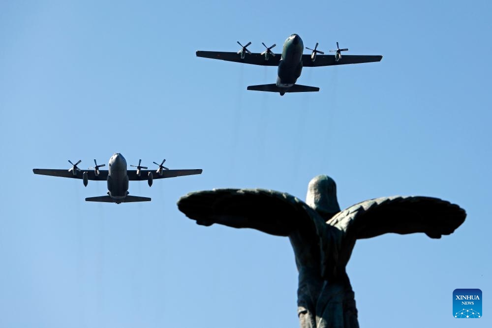 Military airplanes fly over the Statue of Air Heroes during celebrations of the Romanian Aviation and Air Force Day in Bucharest, Romania, July 20, 2025. (Photo: Xinhua)