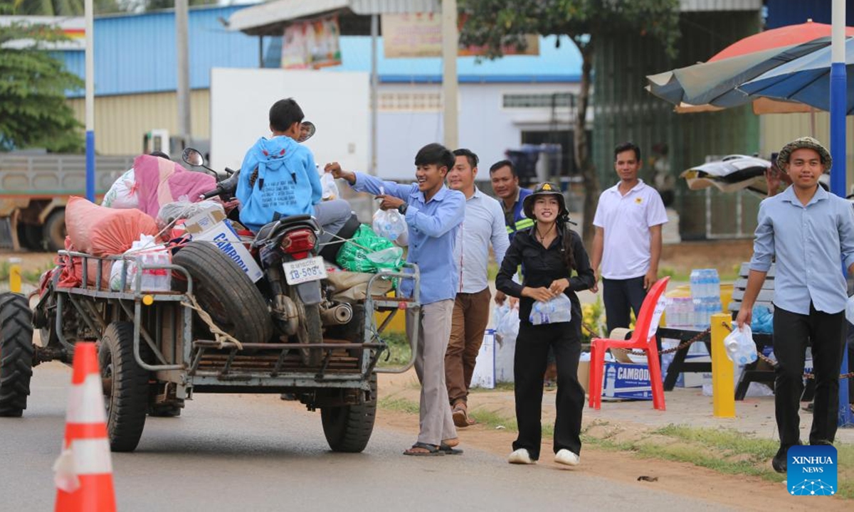 Cambodian villagers from Oddar Meanchey province receive drinking water after fleeing their homes to seek refuge in Siem Reap province, Cambodia, July 25, 2025. At least 13 Cambodian people died and 71 others were injured in border clashes with Thailand, a Cambodian defense spokesperson said Saturday. According to Thai media, the border clashes started for the third day on Saturday morning after the Cambodian side opened fire against Thai troops. (Photo by Sao Khuth/Xinhua)