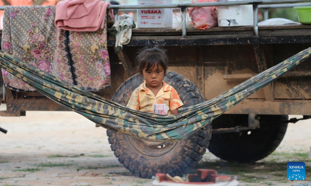 A little girl, who fled with her family from the border in Oddar Meanchey province, sits on a hammock at a refuge in Siem Reap province, Cambodia, July 25, 2025. At least 13 Cambodian people died and 71 others were injured in border clashes with Thailand, a Cambodian defense spokesperson said Saturday. According to Thai media, the border clashes started for the third day on Saturday morning after the Cambodian side opened fire against Thai troops. (Photo by Sao Khuth/Xinhua)