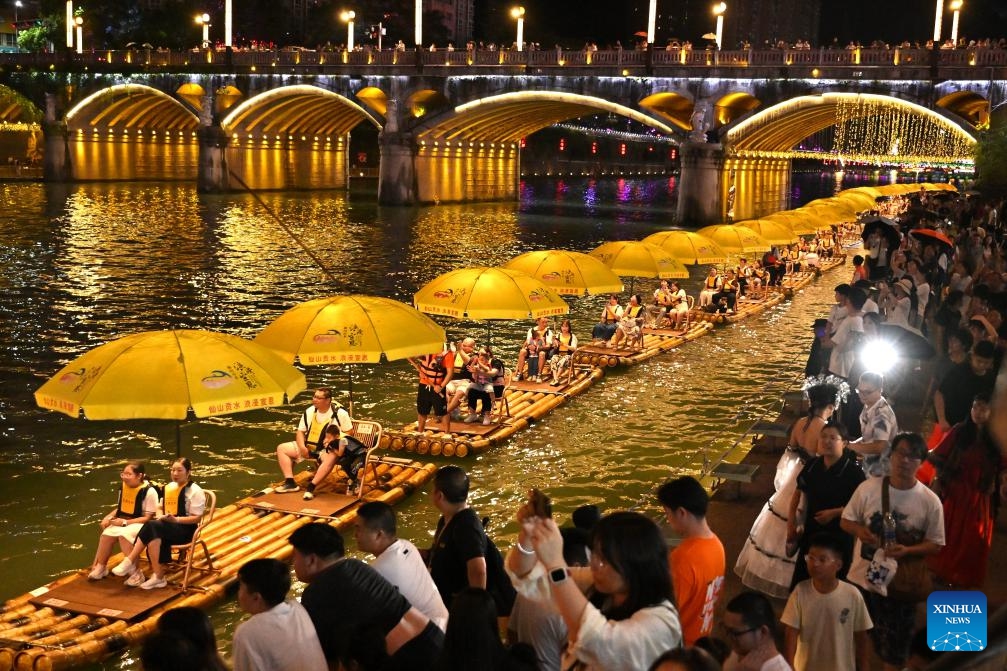 Tourists take bamboo rafts at a scenic area in Xuan'en County, Enshi Tujia and Miao Autonomous Prefecture, central China's Hubei Province, July 24, 2025. With heat waves gripping many regions across the country, diverse cooling tourism events, such as water-related activities and night tours, have grown in popularity, invigorating the summer economy. (Photo: Xinhua)