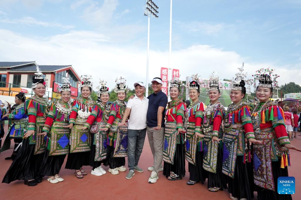 Tourists and cheerleading squad in ethnic costumes pose for photo during the restart ceremony of the Village Super League, also known as Cun Chao, staged in Rongjiang County, Guizhou Province in southwest China, July 26, 2025. (Photo: Xinhua)