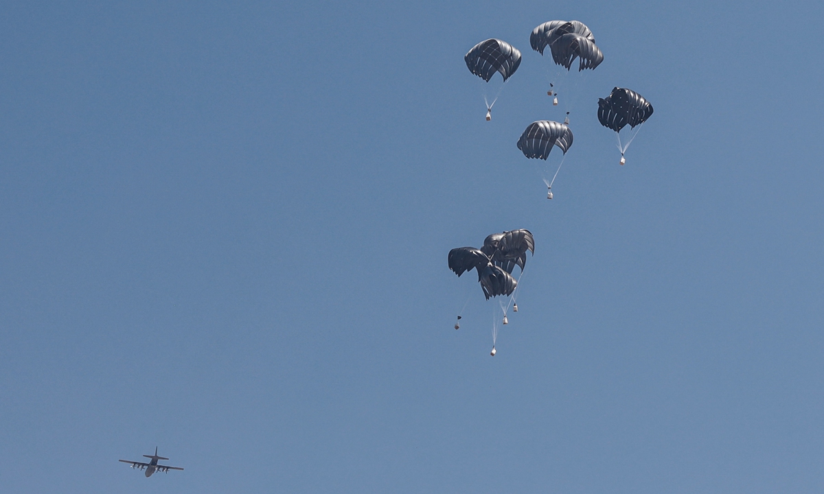 An aircraft drops humanitarian aid balloons over the al-Sudaniyya area of Gaza City, Gaza on July 27, 2025. The Israeli military has begun a 