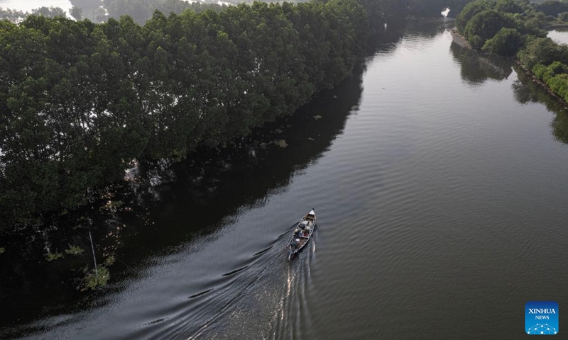 A drone photo shows a fishing boat returning home along a river, flanked by mangrove trees, at Tarumajaya village of Bekasi district, in West Java province, Indonesia, July 26, 2025. July 26 marks the International Day for the Conservation of the Mangrove Ecosystem. Adopted by the General Conference of the United Nations Educational, Scientific and Cultural Organisation (UNESCO) in 2015, this special day aims to raise awareness of the importance of mangrove ecosystems as unique, special and vulnerable ecosystem and to promote solutions for their sustainable management, conservation and uses. (Photo: Xinhua)