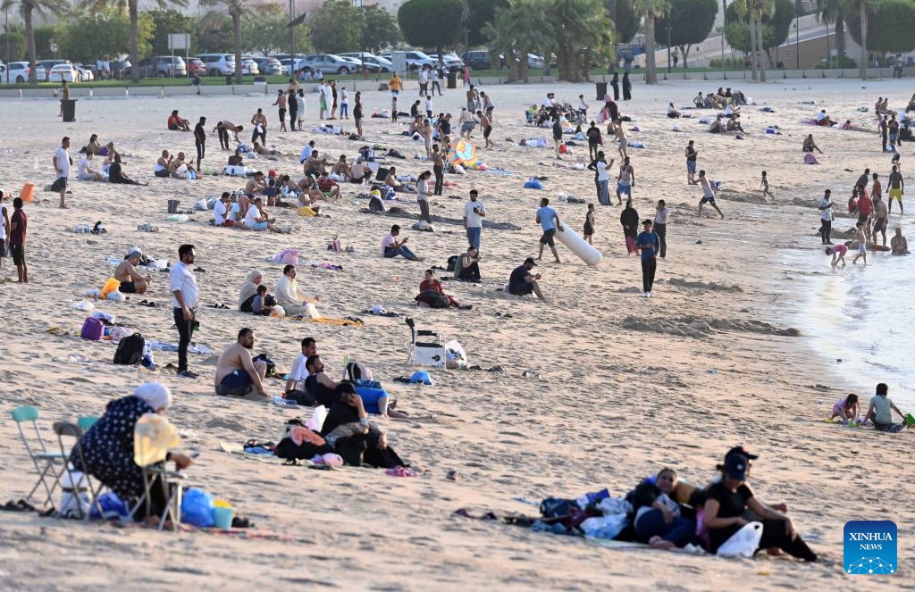 People enjoy themselves on the beach in Hawalli Governorate, Kuwait, July 26, 2025. As temperatures in Kuwait soared, residents flocked to the beach to escape the intense summer heat. (Photo: Xinhua)