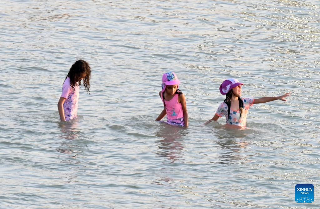 People cool off in the sea near the shore in Hawalli Governorate, Kuwait, July 26, 2025. As temperatures in Kuwait soared, residents flocked to the beach to escape the intense summer heat. (Photo: Xinhua)