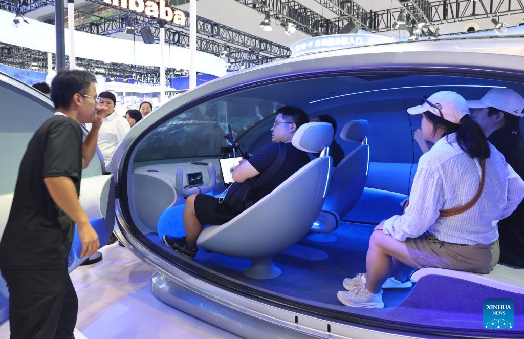 Visitors experience a ride in a next-generation intelligent cockpit system based on a large model by StepFun at the 2025 World AI Conference in east China's Shanghai, July 27, 2025. The ongoing 2025 World AI Conference showcases the world's latest AI advancements while providing a platform for visitors to access AI products and technologies. (Photo: Xinhua)