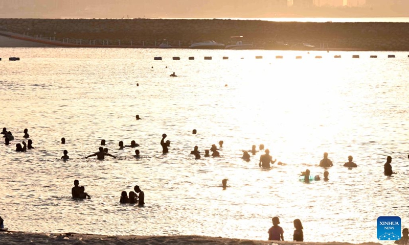 People cool off in the sea near the shore in Hawalli Governorate, Kuwait, July 26, 2025. As temperatures in Kuwait soared, residents flocked to the beach to escape the intense summer heat. (Photo: Xinhua)