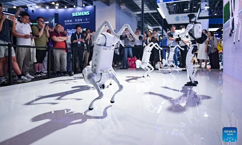 China Mobile's self-developed robot dogs and humanoid robot dance at the company's booth during the 2025 World AI Conference in east China's Shanghai, July 27, 2025. The ongoing 2025 World AI Conference showcases the world's latest AI advancements while providing a platform for visitors to access AI products and technologies. (Photo: Xinhua)