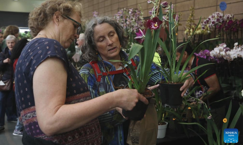 People visit an orchid expo in San Francisco, the United States, July 26, 2025. The two-day orchid expo kicked off at the Golden Gate Park in San Francisco on Saturday.（Photo: Xinhua)