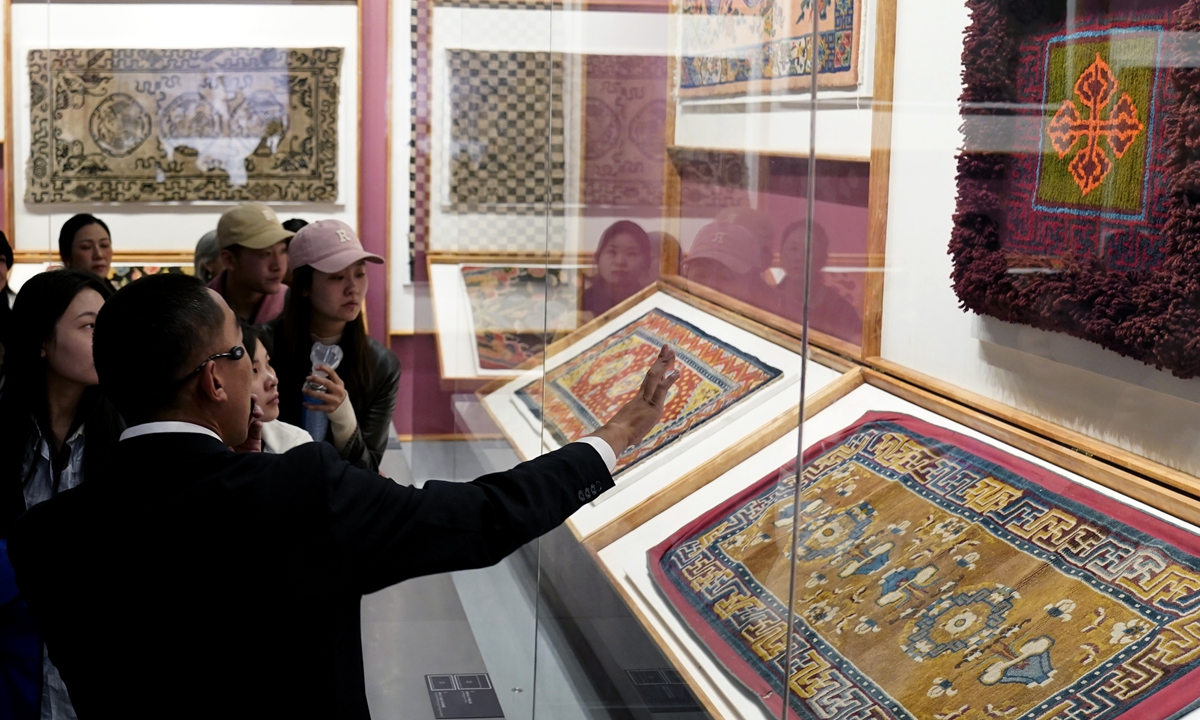 Visitors view Tibetan carpets on display at the Xizang Museum in Lhasa on October 19, 2024. Photo: VCG
