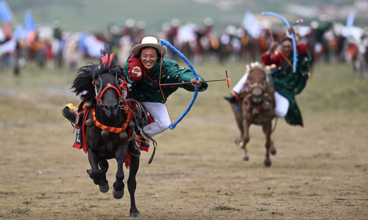 Herdsmen perform horseback archery during the opening ceremony of a horse racing culture and tourism festival in Litang county, Southwest China's Sichuan Province, on July 30, 2025. Both tourists and local residents flocked to this equestrian spectacle. Photo: VCG