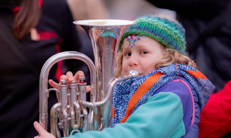A little girl performs a brass instrument in the Light Up Lyneham winter community celebration in Canberra, Australia, Aug. 2, 2025. The Light Up Lyneham 2025 winter community celebration took place on Saturday in Canberra, featuring food, music, lion dance performance, artistic lighting and lantern display. Photo: Xinhua
