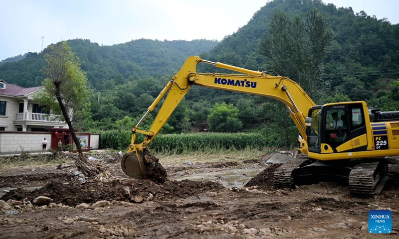 A staff member operates a digger to repair a damaged road in Nantai Village in Liudaohe Town, Xinglong County of north China's Hebei Province, Aug. 2, 2025. Affected by heavy rainfall, some roads and houses were damaged in several villages in Liudaohe Town. In recent days, local authorities have organized efforts to carry out relief operations to restore roads, power supply and communication facilities, along with environmental disinfection measures. Photo: Xinhua