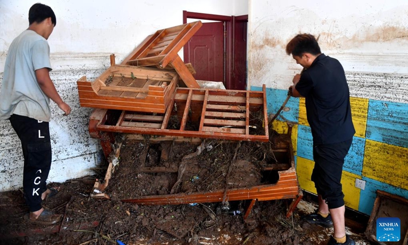 Villagers clean their home in Liudaogou Village in Liudaohe Town, Xinglong County of north China's Hebei Province, Aug. 1, 2025. Affected by heavy rainfall, some roads and houses were damaged in several villages in Liudaohe Town. In recent days, local authorities have organized efforts to carry out relief operations to restore roads, power supply and communication facilities, along with environmental disinfection measures. Photo: Xinhua
