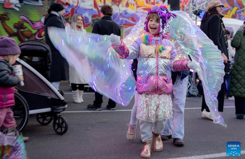 A little girl wearing an artistic light costume is pictured in the Light Up Lyneham winter community celebration in Canberra, Australia, Aug. 2, 2025. The Light Up Lyneham 2025 winter community celebration took place on Saturday in Canberra, featuring food, music, lion dance performance, artistic lighting and lantern display. Photo: Xinhua