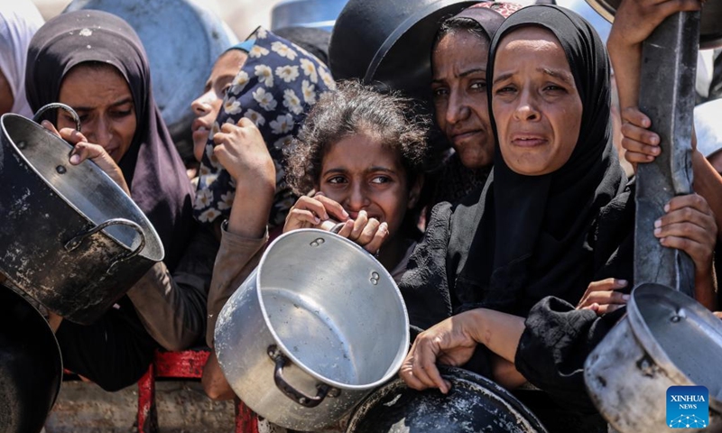 Palestinians wait to receive free food from a food distribution center in Gaza City, on Aug. 2, 2025. Photo: Xinhua