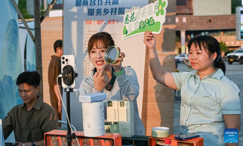 People promote vine tea products via livestreaming in Laifeng County of Enshi Tujia and Miao Autonomous Prefecture, central China's Hubei Province, Aug. 1, 2025. Laifeng County has leveraged comprehensive industrial chain development to optimize the business ecosystem for vine tea cultivation. The county has expanded its vine tea plantations to 102,000 mu (about 6,800 hectares), generating an annual output value of 2.253 billion yuan (about 321.4 million U.S. dollars). The industry has lifted household incomes for over 20,000 rural families. Photo: Xinhua