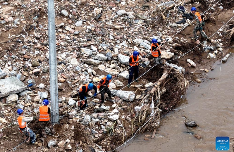 A drone photo shows staff members from the State Grid Corporation of China repairing power supply facilities in Nantai Village in Liudaohe Town, Xinglong County of north China's Hebei Province, Aug. 2, 2025. Affected by heavy rainfall, some roads and houses were damaged in several villages in Liudaohe Town. In recent days, local authorities have organized efforts to carry out relief operations to restore roads, power supply and communication facilities, along with environmental disinfection measures. Photo: Xinhua