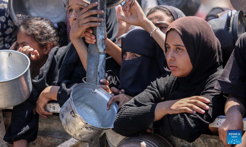 Palestinians wait to receive free food from a food distribution center in Gaza City, on Aug. 2, 2025. Photo: Xinhua