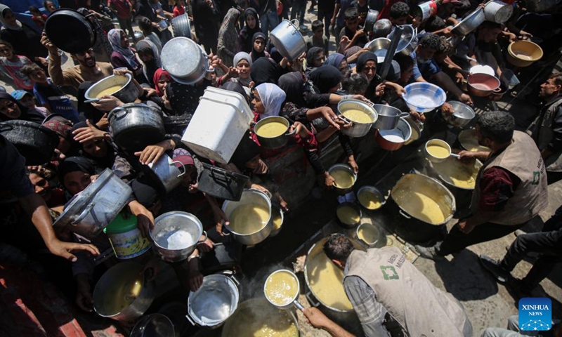 Palestinians wait to receive free food from a food distribution center in Gaza City, on Aug. 2, 2025. Photo: Xinhua
