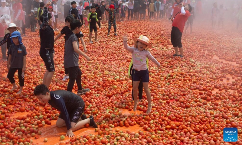 People play in a tomato pool during Hwacheon Tomato Festival in Hwacheon-gun, South Korea, Aug. 2, 2025. Photo: Xinhua