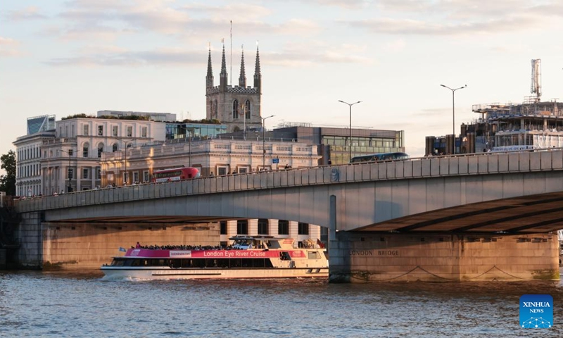 A cruise ship passes under London Bridge at sunset in London, Britain, Aug. 2, 2025. Photo: Xinhua