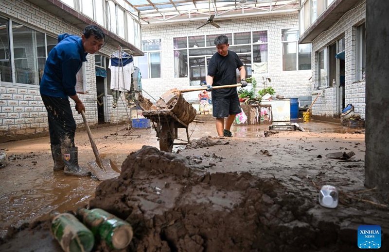 Villagers clean up silt in Liudaogou Village in Liudaohe Town, Xinglong County of north China's Hebei Province, Aug. 1, 2025. Affected by heavy rainfall, some roads and houses were damaged in several villages in Liudaohe Town. In recent days, local authorities have actively organized efforts to carry out relief operations to restore roads, power supply, and communication facilities, along with environmental disinfection measures. Photo: Xinhua