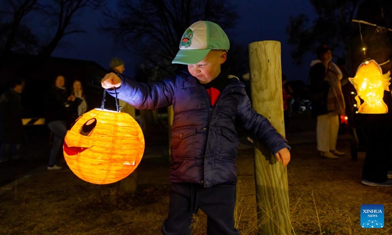 A little boy holds a lantern in the Light Up Lyneham winter community celebration in Canberra, Australia, Aug. 2, 2025. The Light Up Lyneham 2025 winter community celebration took place on Saturday in Canberra, featuring food, music, lion dance performance, artistic lighting and lantern display. Photo: Xinhua