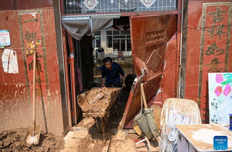 A villager cleans up silt in Liudaogou Village in Liudaohe Town, Xinglong County of north China's Hebei Province, Aug. 1, 2025. Affected by heavy rainfall, some roads and houses were damaged in several villages in Liudaohe Town. In recent days, local authorities have actively organized efforts to carry out relief operations to restore roads, power supply, and communication facilities, along with environmental disinfection measures. Photo: Xinhua