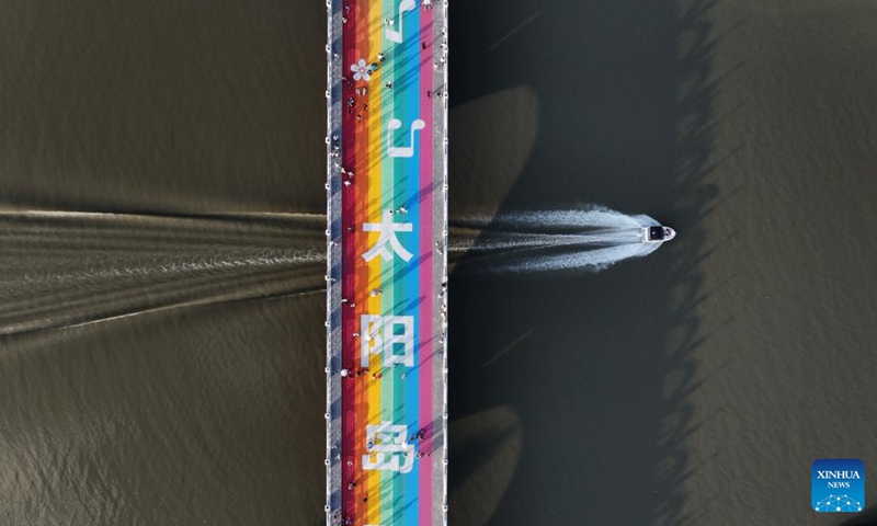 An aerial drone photo taken on July 27, 2025 shows a boat sailing across the rainbow bridge leading to Sun Island Scenic Area, in Harbin, northeast China's Heilongjiang Province. Located on the north bank of the Songhua River in Harbin, the Taiyangdao (Sun Island) National Wetland Park has a wetland area of more than 7,000 hectares, with a high wetland rate of more than 70 percent. Among them, the Sun Island Scenic Area is one of the few riverfront wetland grassland ecological zones lying in the city center in China.

In midsummer, the charming scenery of the vibrant urban ecological island attracts numerous tourists. Photo: Xinhua