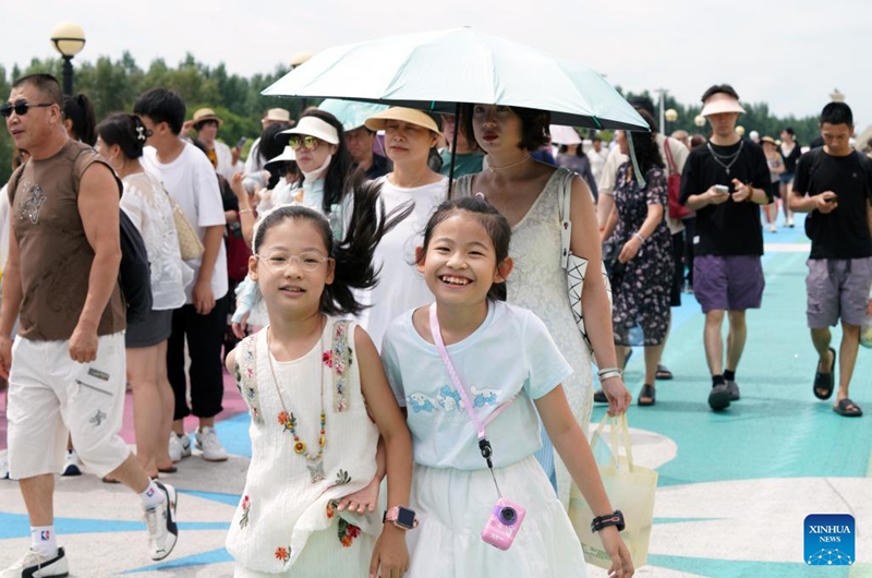 People visit the Sun Island Scenic Area in Harbin, northeast China's Heilongjiang Province, July 31, 2025. Located on the north bank of the Songhua River in Harbin, the Taiyangdao (Sun Island) National Wetland Park has a wetland area of more than 7,000 hectares, with a high wetland rate of more than 70 percent. Among them, the Sun Island Scenic Area is one of the few riverfront wetland grassland ecological zones lying in the city center in China.

In midsummer, the charming scenery of the vibrant urban ecological island attracts numerous tourists. Photo: Xinhua
