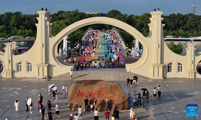 A drone photo shows people posing for photos at the Sun Island Scenic Area in Harbin, northeast China's Heilongjiang Province, July 27, 2025. Located on the north bank of the Songhua River in Harbin, the Taiyangdao (Sun Island) National Wetland Park has a wetland area of more than 7,000 hectares, with a high wetland rate of more than 70 percent. Among them, the Sun Island Scenic Area is one of the few riverfront wetland grassland ecological zones lying in the city center in China.

In midsummer, the charming scenery of the vibrant urban ecological island attracts numerous tourists. Photo: Xinhua