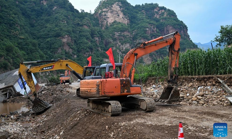 Staff members operate diggers to repair a damaged road in Liudaogou Village in Liudaohe Town, Xinglong County of north China's Hebei Province, Aug. 1, 2025. Affected by heavy rainfall, some roads and houses were damaged in several villages in Liudaohe Town. In recent days, local authorities have actively organized efforts to carry out relief operations to restore roads, power supply, and communication facilities, along with environmental disinfection measures. Photo: Xinhua