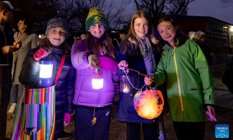 People hold lanterns to participate in the Light Up Lyneham winter community celebration in Canberra, Australia, Aug. 2, 2025. The Light Up Lyneham 2025 winter community celebration took place on Saturday in Canberra, featuring food, music, lion dance performance, artistic lighting and lantern display. Photo: Xinhua