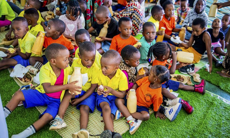 Children share and enjoy milk during a national harvest day celebration in Kicukiro District, Rwanda, Aug. 1, 2025. Photo: Xinhua
