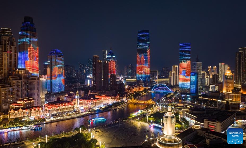 An aerial drone photo taken on Aug. 1, 2025 shows a night view along the Haihe River in north China's Tianjin. To improve its urban landscape at night, Tianjin has upgraded the lighting installations for 216 buildings, 13 bridges, 8.2 kilometers of riverbanks and 7 piers along the Haihe River so far in 2025. Photo: Xinhua