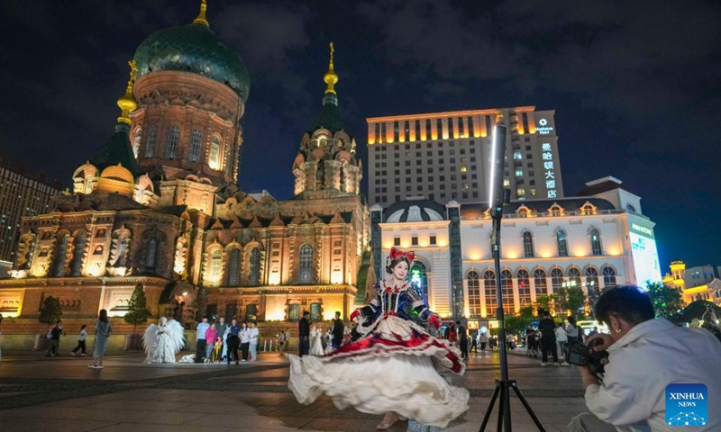 A dressed-up tourist poses for photos in front of the St. Sophia Cathedral in Harbin, northeast China's Heilongjiang Province, on June 8, 2025.
Attracted by the coolness in summer, many tourists come to Harbin for vacation.
Taking advantage of its historical heritage, Harbin in recent years has accelerated the transformation of historical and cultural blocks and the utilization of old buildings, which has promoted the prosperity of the city's tourism industry. Photo: Xinhua