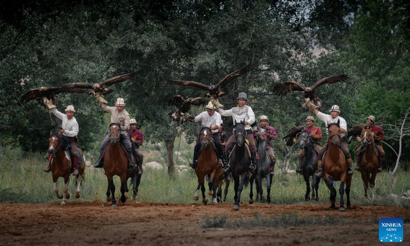 People participate in a hunting performance during a folk arts festival at the south bank of the Issyk-Kul Lake, Kyrgyzstan, Aug. 2, 2025. Photo: Xinhua