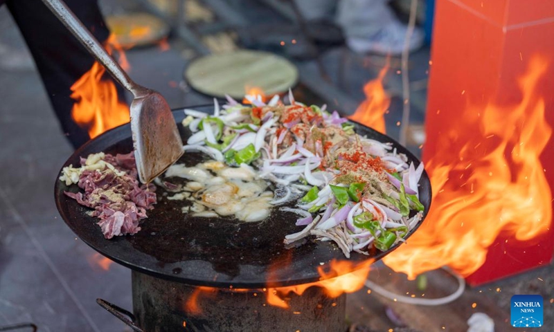 A chef cooks Chaobola, a street food listed as municipal-level intangible cultural heritage, at a food festival in Zhangye, northwest China's Gansu Province, Aug. 2, 2025. Photo: Xinhua