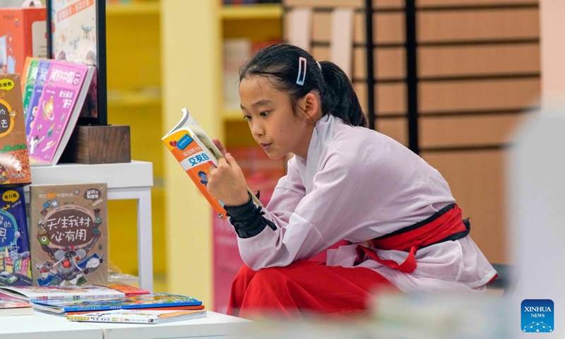 A child reads at a book store in Zunhua, north China's Hebei Province, Aug. 3, 2025. Photo: Xinhua