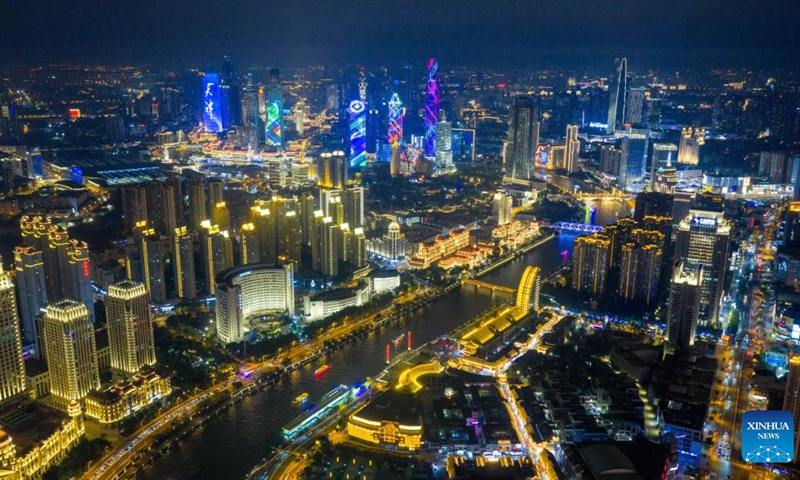 An aerial drone photo taken on Aug. 1, 2025 shows a night view along the Haihe River in north China's Tianjin. To improve its urban landscape at night, Tianjin has upgraded the lighting installations for 216 buildings, 13 bridges, 8.2 kilometers of riverbanks and 7 piers along the Haihe River so far in 2025. Photo: Xinhua