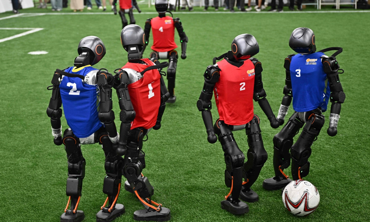 Humanoid robots vie for the ball during an exhibition football match in Beijing on August 4, 2025, ahead of the World Humanoid Robot Games. The capital will host the games from August 15 to 17. Photo: VCG