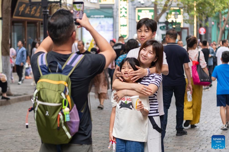 Tourists pose for photos on the Central Street in Harbin, northeast China's Heilongjiang Province, on Aug. 1, 2025.
Attracted by the coolness in summer, many tourists come to Harbin for vacation.
Taking advantage of its historical heritage, Harbin in recent years has accelerated the transformation of historical and cultural blocks and the utilization of old buildings, which has promoted the prosperity of the city's tourism industry. Photo: Xinhua