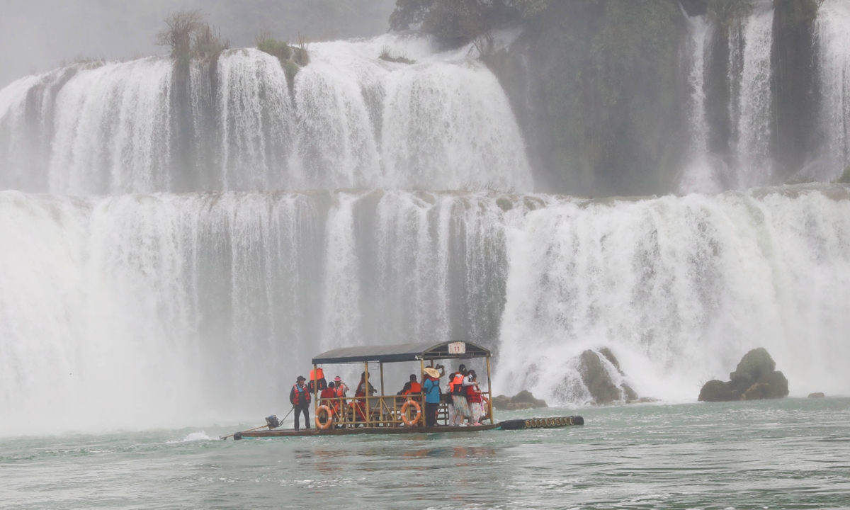 Tourists enjoy a boat tour at the Detian Waterfall in Daxin county, South China's Guangxi Zhuang Autonomous Region, on August 4, 2025. The China-Vietnam Detian-Ban Gioc Waterfall is the biggest cross-border waterfall in Asia. Photo: VCG