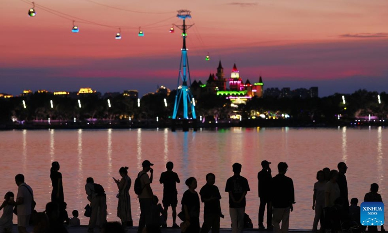 People enjoy the sunset glow by the Songhua River in Harbin, northeast China's Heilongjiang Province, on July 25, 2025.
Attracted by the coolness in summer, many tourists come to Harbin for vacation.
Taking advantage of its historical heritage, Harbin in recent years has accelerated the transformation of historical and cultural blocks and the utilization of old buildings, which has promoted the prosperity of the city's tourism industry. Photo: Xinhua