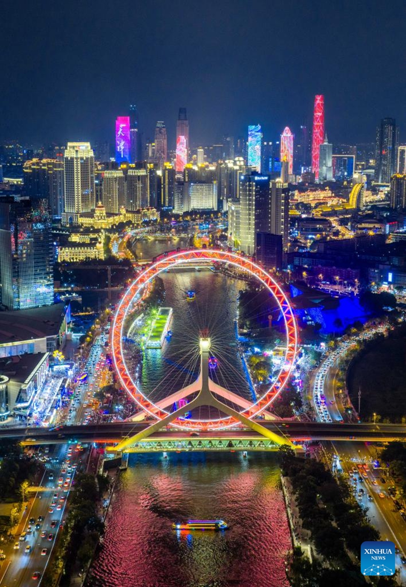 An aerial drone photo taken on Aug. 1, 2025 shows a night view along the Haihe River in north China's Tianjin. To improve its urban landscape at night, Tianjin has upgraded the lighting installations for 216 buildings, 13 bridges, 8.2 kilometers of riverbanks and 7 piers along the Haihe River so far in 2025. Photo: Xinhua