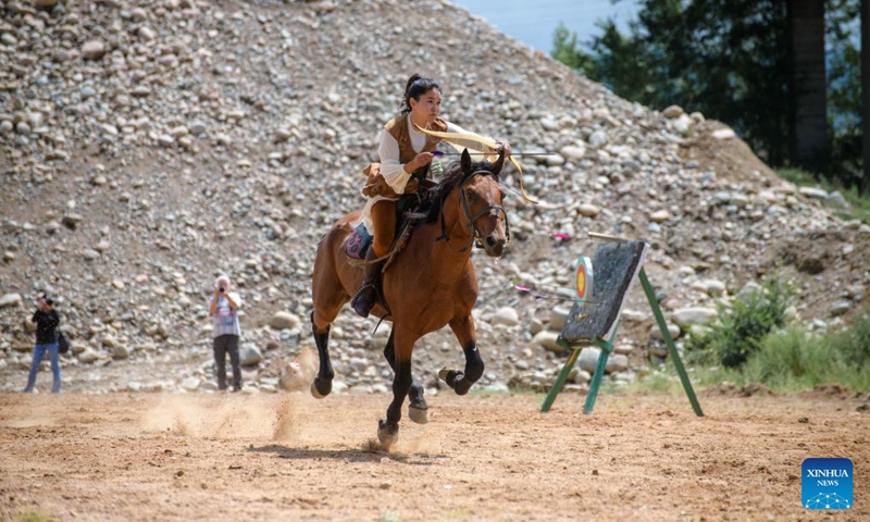 A woman participates in a horseback archery performance during a folk arts festival at the south bank of, Aug. 2, 2025. Photo: Xinhua