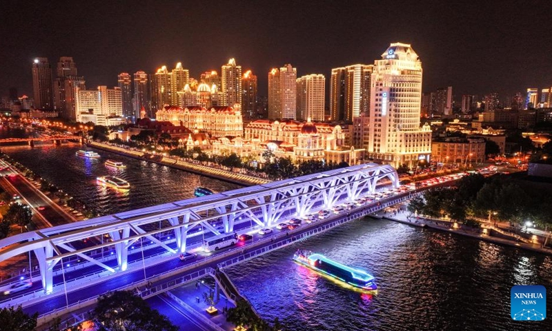 A drone photo taken on July 19, 2025 shows cruise ships sailing on the Haihe River in north China's Tianjin. To improve its urban landscape at night, Tianjin has upgraded the lighting installations for 216 buildings, 13 bridges, 8.2 kilometers of riverbanks and 7 piers along the Haihe River so far in 2025. Photo: Xinhua