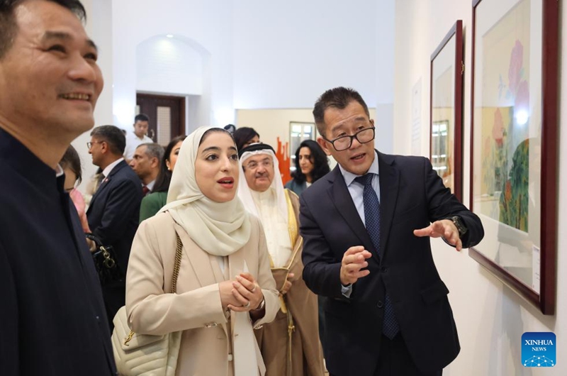 Bahrain's Minister of Tourism, Fatima Al Sairafi (C, front), Chinese Ambassador to Bahrain Ni Ruchi (R, front) and Chinese artist Su Xiaofeng (L, front) view paintings at a Chinese fine brushwork painting exhibition in Manama, Bahrain, on Aug. 3, 2025. A Chinese fine brushwork painting exhibition opened on Sunday at the Bahrain Art Centre in Manama, Bahrain, showcasing nearly 50 flower-and-bird artworks by Chinese artist Su Xiaofeng.(Xinhua/Luo Chen)